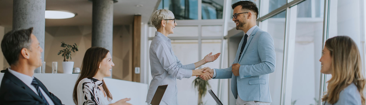 Business People In Meeting Shaking Hands