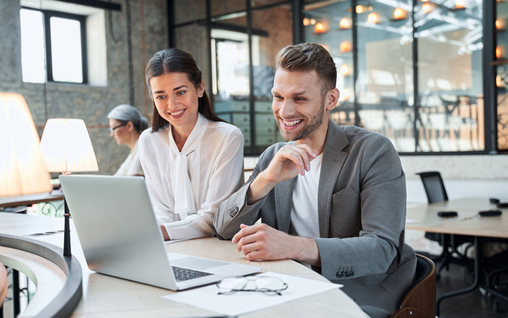 Two Business People Looking At Laptop