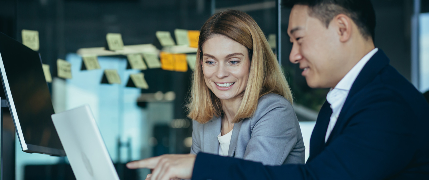 Two Business People Talking Pointing At Laptop