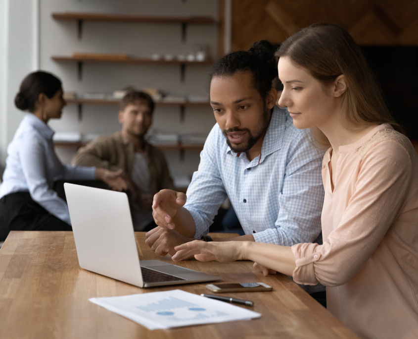 Two Workers Talking At Computer